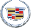 The Cadillac logo, featuring a detailed crest with red, blue, and gold geometric shapes, encased in a silver laurel wreath, representing the luxury American automobile brand.