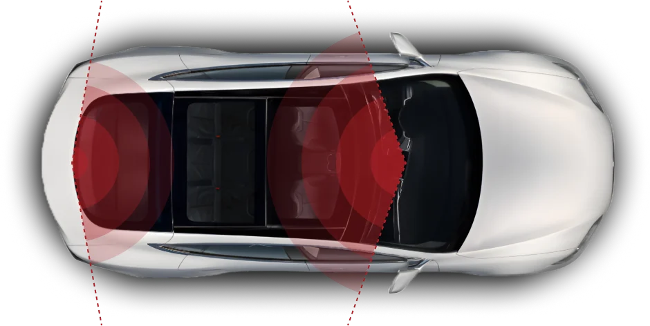 A top-down view of a white car with red-highlighted sensor coverage areas on the front, sides, and rear, illustrating its advanced safety and driver-assistance systems.