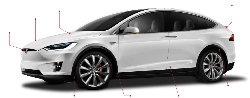A white Tesla Model X with various parts labeled in red text, highlighting areas such as the underside of the hood, shock towers, firewall, under bumpers, complete underbody, inside doors, wheel wells, and lift gate. The image appears to illustrate key structural or protective areas of the vehicle.